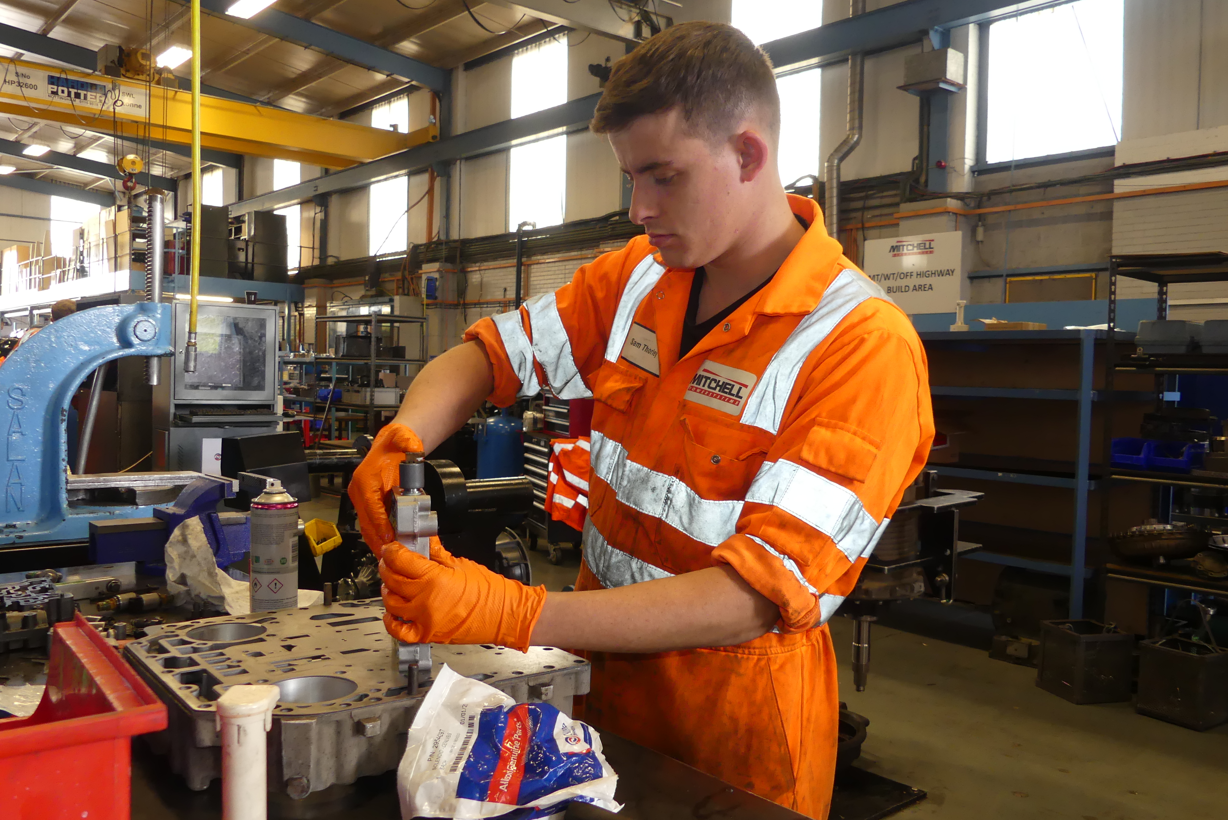 Mitchell Powersystems employee working on a transmission unit