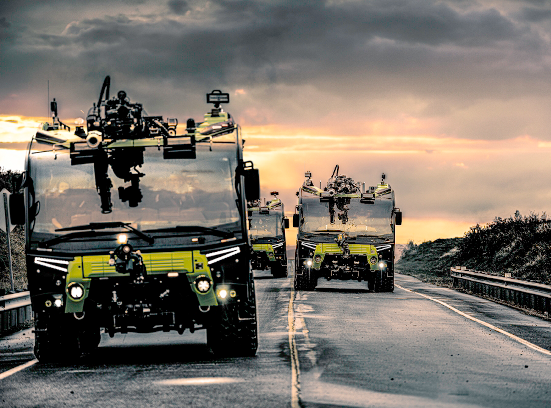 Fire engines driving down road towards camera